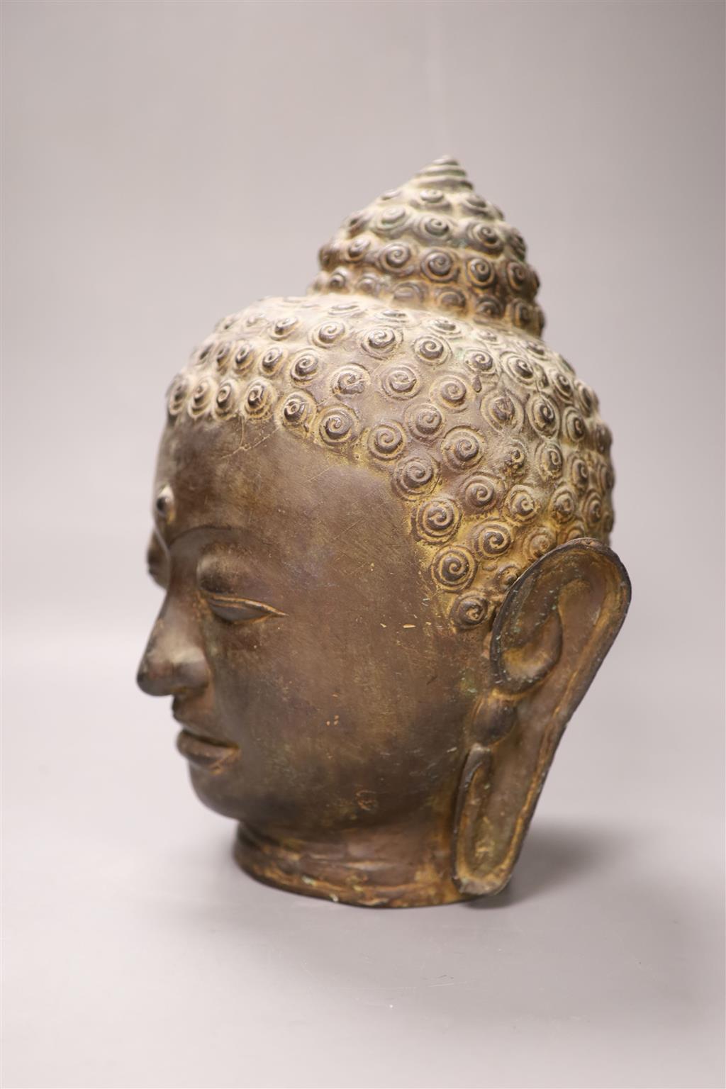 A Sino Tibetan bronze buddha head, height 33cm